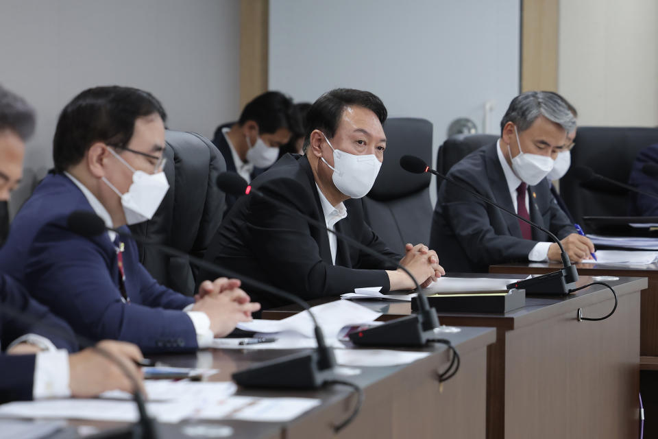 In this photo provided by South Korea Presidential Office, South Korean President Yoon Suk Yeol, center, attends at the National Security Council (NSC) meeting at the presidential office in Seoul, South Korea, Sunday, June 5, 2022. North Korea test-fired a barrage of short-range ballistic missiles from multiple locations toward the sea on Sunday, South Korea's military said, extending a provocative streak in weapons demonstrations this year that U.S. and South Korean officials say may culminate with a nuclear test explosion. (South Korea Presidential Office via AP)