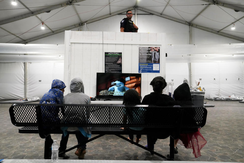 Image: Young asylum-seekers watch a movie at the Donna Soft-Sided Processing Facility (Veronica G. Cardenas / Reuters file)