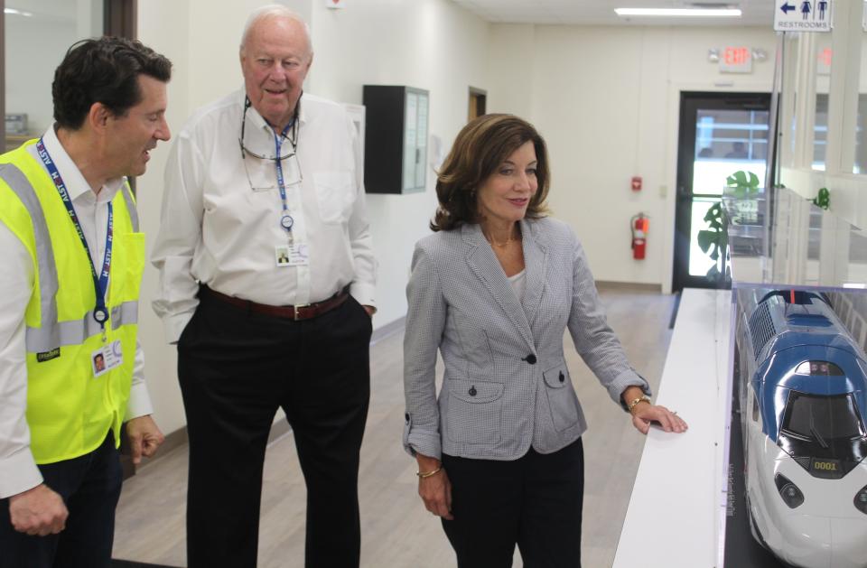 Then-Lieutenant Governor Kathy Hochul, right, looks over a model of the new high speed line as Alstom Vice President of Public Affairs John Cohen and Hornell IDA Executive Director Jim Griffin look on during a tour of the Hornell facility.