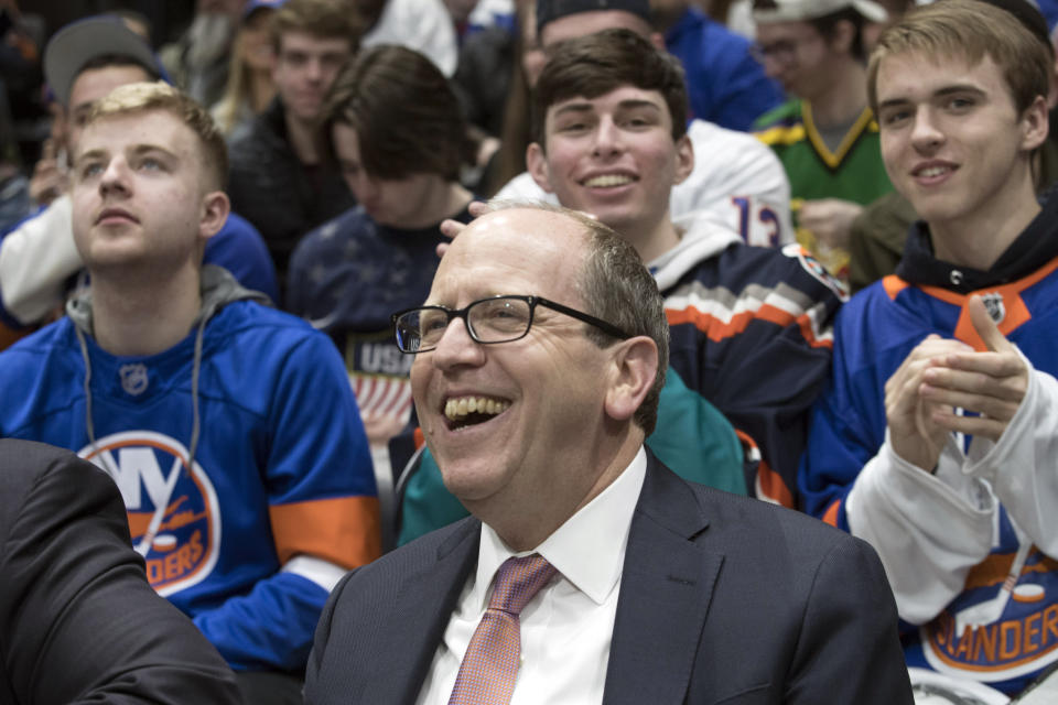 FILE - In this Thursday, March 14, 2019, file photo, Jon Ledecky, majority owner of the New York Islanders, watches NHL hockey game action during the second period against the Montreal Canadiens, in Uniondale, N.Y. The New York Islanders have reached a 20-year naming rights deal for their new arena with wealth management service UBS. The facility on the grounds of the Belmont Park racetrack will be called UBS Arena at Belmont Park. It's projected to open in time for the 2021-22 NHL season. (AP Photo/Mary Altaffer, File)