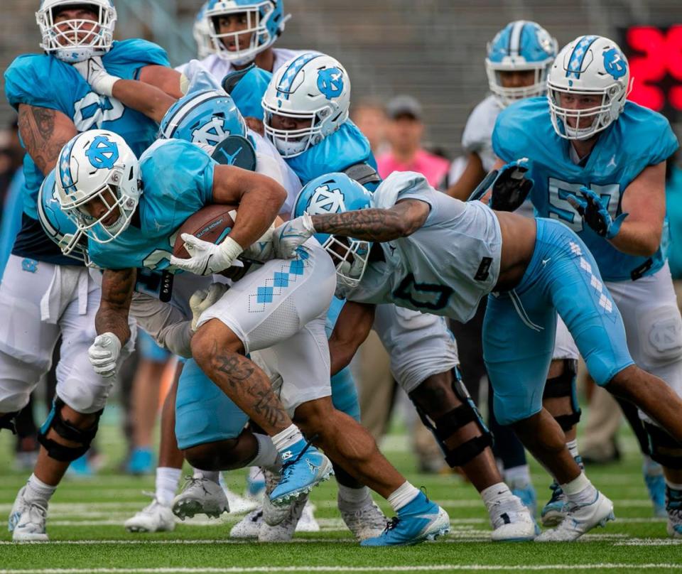 North Carolina defensive back Ja’Qurious Conley (0) works to stop running back Omarion Hampton (28) during a scrimmage at the Tar Heels’ open practice on Saturday, March 25, 2023 at Kenan Stadium in Chapel Hill. N.C