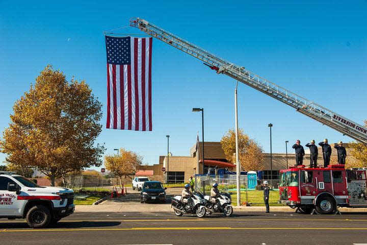 A vehicle procession in Riverside County begins to escort the body of fallen Apple Valley Fire Engineer Jared Shepard back to the town where he served.