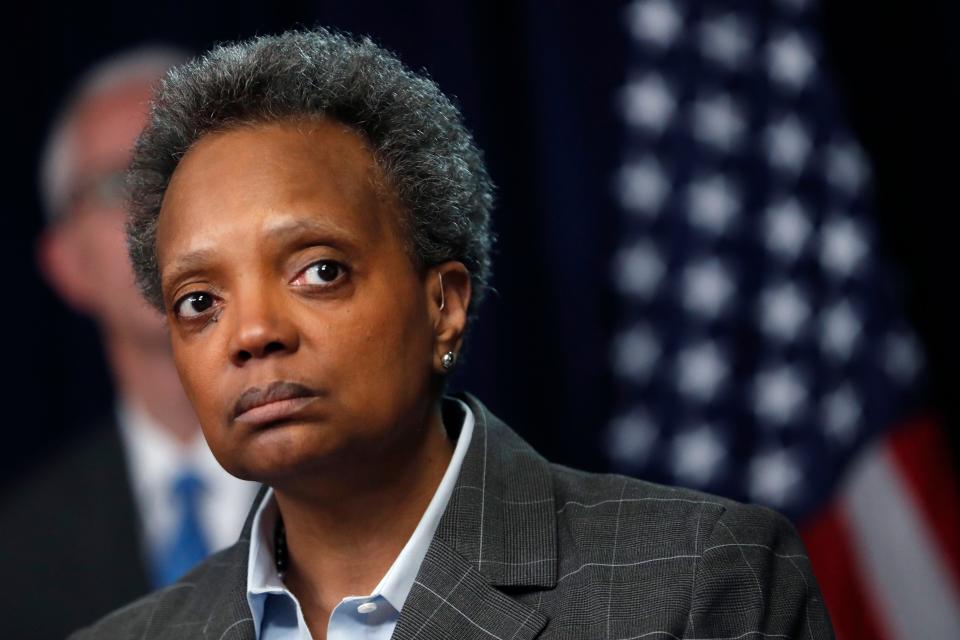 Chicago Mayor Lori Lightfoot listens to a question after Illinois Gov. J.B. Pritzker announced a shelter-in-place order to combat the spread of COVID-19.