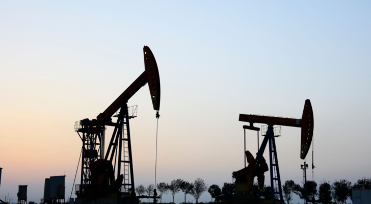 In the field, the oil pump in the evening, the evening silhouette of the pumping unit, the silhouette of the oil pump. Oil stocks