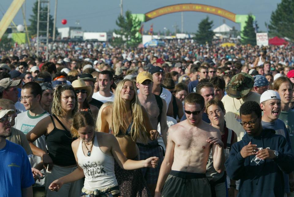 Fans dance as the rock band Phish performs during the first day the band's two-day "It" festival Saturday, Aug. 2, 2003, before a crowd estimated at 60,000 at the former Loring Air Force Base in Limestone, Maine.
