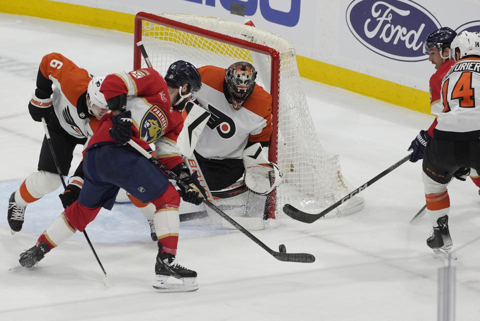 Philadelphia Flyers goaltender Samuel Ersson (33) defends the net against a shot by Florida Panthers left wing Jonah Gadjovich during the second period of an NHL hockey game, Tuesday, Feb. 6, 2024, in Sunrise, Fla. (AP Photo/Marta Lavandier)