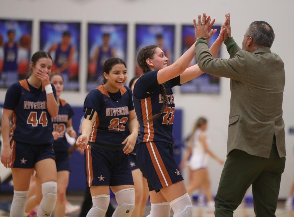 Riverside High School player, Sophiya Bustillos celebrates with her head coach, 
Stephen Solis, during her teamÕs win on the road against Clint High School 52-44.