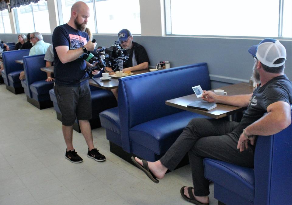 Videographer Matt Patterson films Americana singer Chris Beall, a former Abilene resident, looking at a Polaroid photo of himself with his grandmother, Myrtle Rogers at the Dixie Pig. The longtime Abilene restaurant inspired Beall's song "Big Blue World," which was released as a single Friday; the video will be out soon