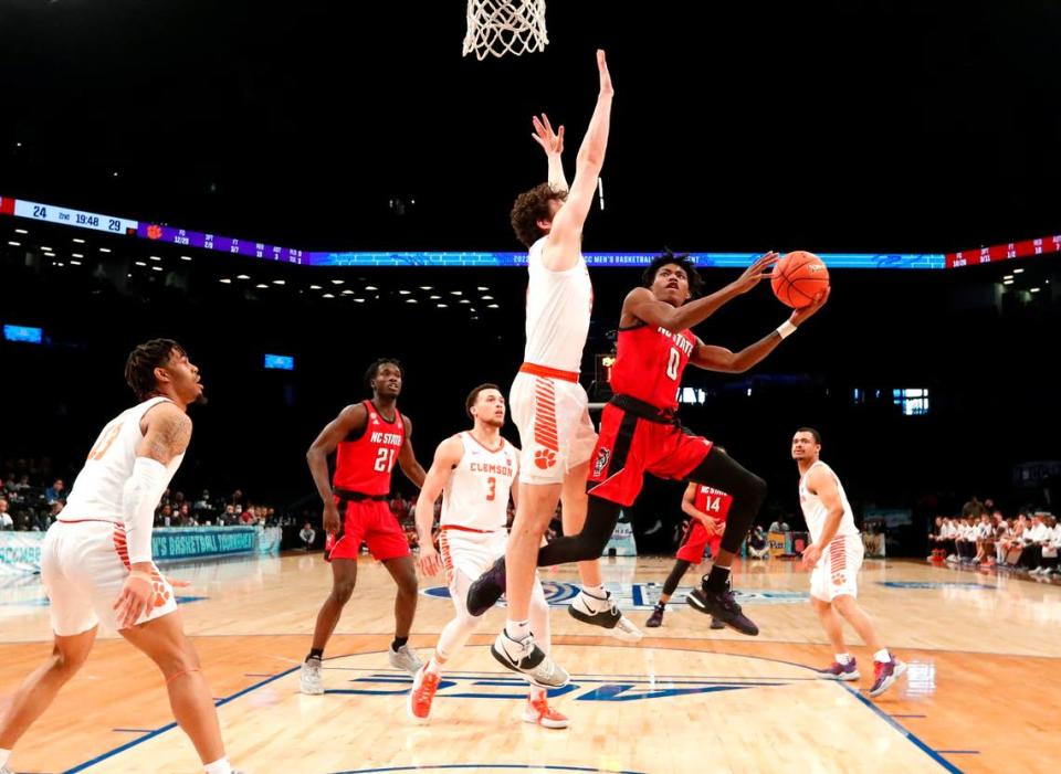 N.C. State’s Terquavion Smith (0) prepares to shoot as Clemson’s PJ Hall (24) defends during Clemson’s 70-64 victory over N.C. State in the first round of the ACC men’s basketball tournament at the Barclays Center in Brooklyn, N.Y., Tuesday, March 8, 2022.