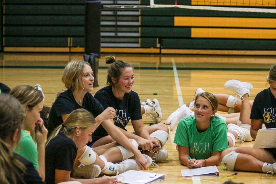 Salina South High School senior Sydney Anderes (center) sits with other seniors at Practice Sept. 8.