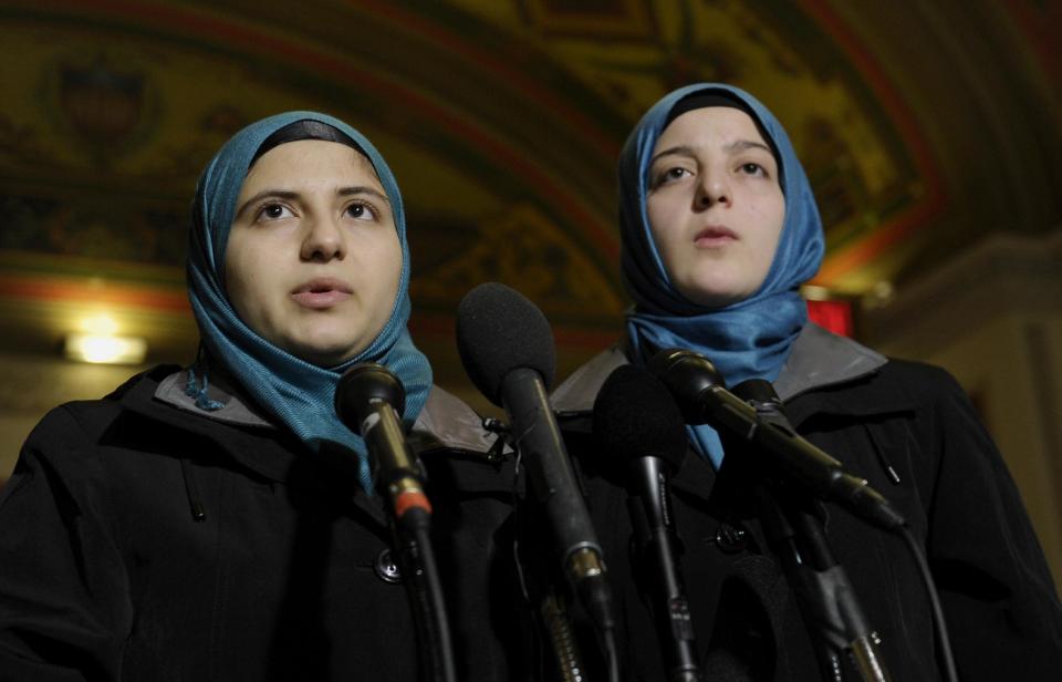 Heba Sawan, left, and her sister Amineh Sawan, right, survivors of the August 2013 chemical weapons attack in Moadamiya, Syria that left more than 1,200 Syrians dead and many more wounded, speak during a news conference on Capitol Hill in Washington, Thursday, Feb. 6, 2014. The sisters had been in a meeting Sen. Tim Kaine, D-Va., chairman of the Senate Foreign Relations subcommittee on Near Eastern, Southern and Central Asian Affairs. (AP Photo/Susan Walsh)