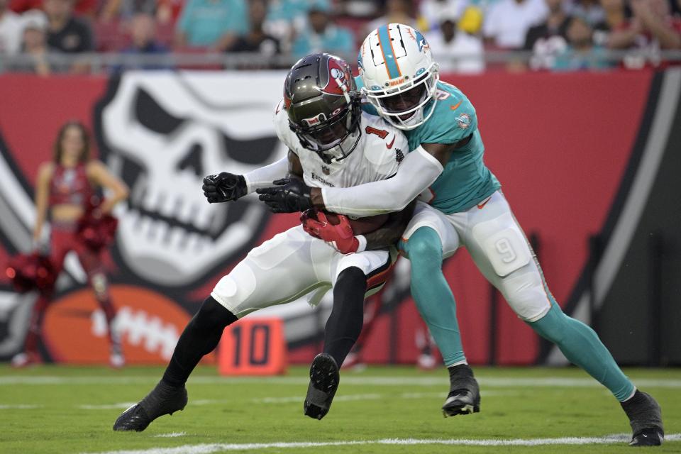 Bucs receiver Jaelon Darden catches a touchdown pass with Dolphins cornerback Noah Igbinoghene in coverage during Saturday night's preseason game in Tampa.