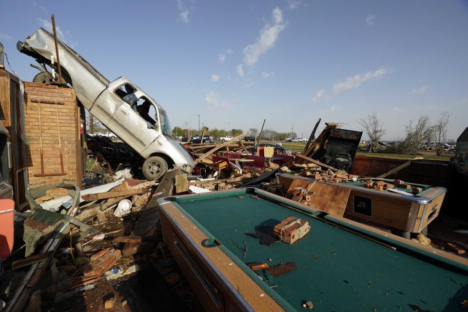 A pickup truck rests on top of a restaurant cooler at Chuck's Dairy Bar in Rolling Fork, Mississippi, on March 25, 2023.
