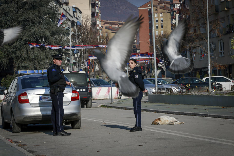 FILE - Kosovo police officers patrol on the bridge dividing southern Albanian and the northern, Serb-dominated part of ethnically divided town of Mitrovica, Kosovo, Thursday, Dec. 29, 2022. A new mayor has been sworn in in northern Kosovo after a vote that was boycotted by the ethnic Serb minority which dominates the area. Erden Atic, who is from the Albanian majority, took up his post in the northern, Serb-dominated part of the divided city of Mitrovica on Friday, May 19, 2023 calling on citizens to cooperate. (AP Photo/Visar Kryeziu, File)