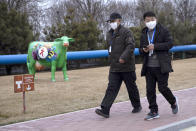 In this Thursday, Feb. 27, 2020, photo, visitors walk past a cow sculpture at a Mengniu dairy factory in Beijing. Reporters were invited to China Mengniu Dairy Co. Ltd. this week to be shown how companies are reviving after anti-virus measures shut down most of the world's second-biggest economy. (AP Photo/Ng Han Guan)