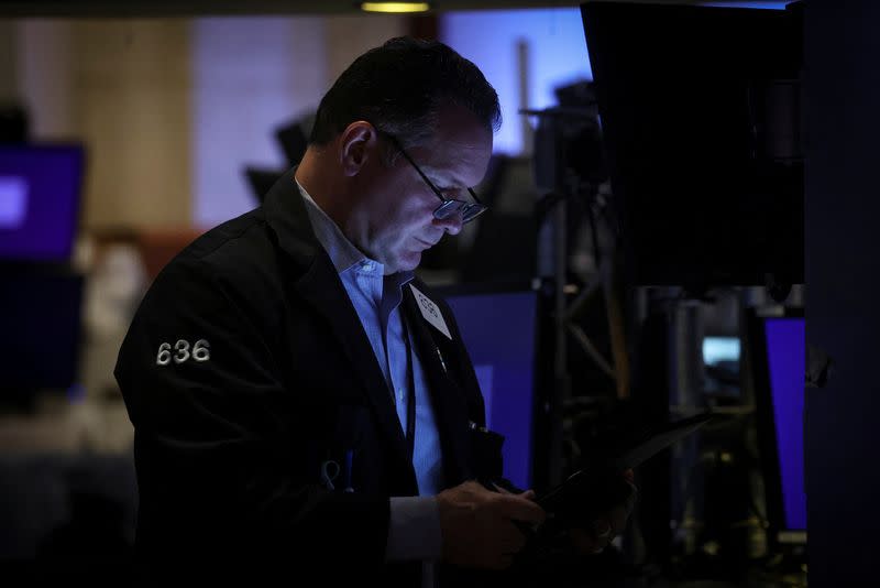 Traders work on the floor of the NYSE in New York