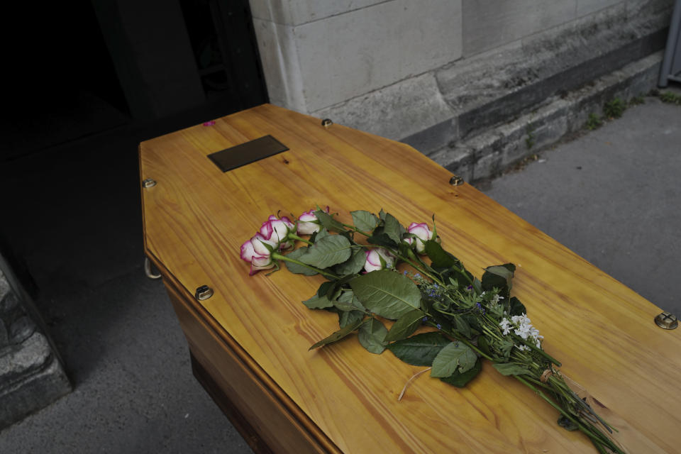 The coffin of an 83-year-old man, is about to enter into the crematorium during a funeral ceremony under the care of Paris undertaker Franck Vasseur at Pere Lachaise cemetery in Paris, Friday, April 24, 2020 as a nationwide confinement continues to counter the COVID-19 virus. (AP Photo/Francois Mori)