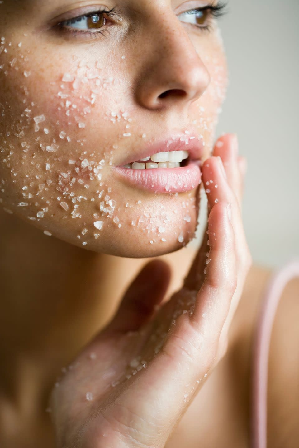 young woman with salt peeling mask