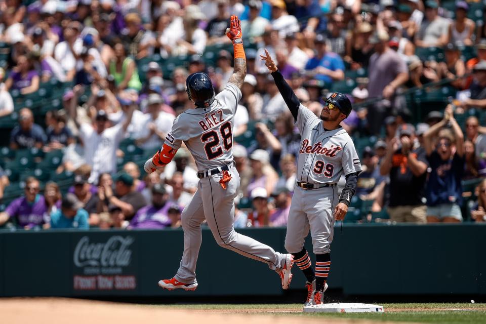 Detroit Tigers shortstop Javier Baez (28) celebrates with first base coach Alfredo Amezaga (99) as he rounds the bases on a grand slam in the first inning against the Colorado Rockies at Coors Field in Denver on Sunday, July 2, 2023.
