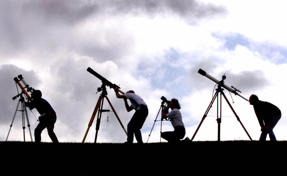 FILE - Members of the British Astronomers Association prepare their telescopes Tuesday, Aug. 10, 1999, at their campsite near Truro, England. The group is preparing for a total solar eclipse which will take place Wednesday. Caulkin, a retired Associated Press photographer has died. He was 77 and suffered from cancer. Known for being in the right place at the right time with the right lens, the London-based Caulkin covered everything from the conflict in Northern Ireland to the Rolling Stones and Britain’s royal family during a career that spanned four decades. (AP Photo/Dave Caulkin, File)