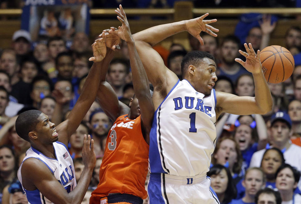 Duke's Jabari Parker (1) and Amile Jefferson, left, struggle for a rebound with Syracuse's Jerami Grant during the second half of an NCAA college basketball game in Durham, N.C., Saturday, Feb. 22, 2014. Duke won 66-60. (AP Photo/Gerry Broome)