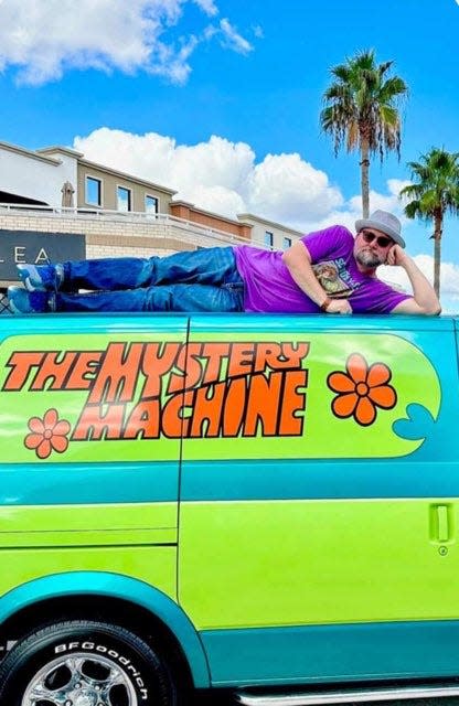 Scott Innes poses for a photo atop The Mystery Machine. Innes is the voice actor for several "Scooby-Doo" characters, including Scooby-Doo, Shaggy and Scrappy.