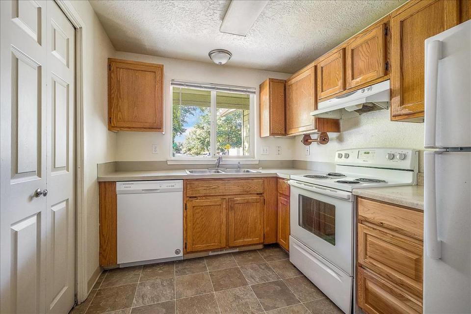 The Dundee house features a full kitchen with a dishwasher, stove and refrigerator.