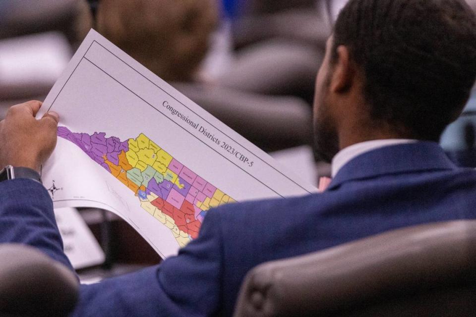 A North Carolina Senate staffer looks over a proposed congressional map during a Senate Committee on Redistricting and Elections meeting at the Legislative Office Building in Raleigh, Thursday, October. 19, 2023. Travis Long/tlong@newsobserver.com