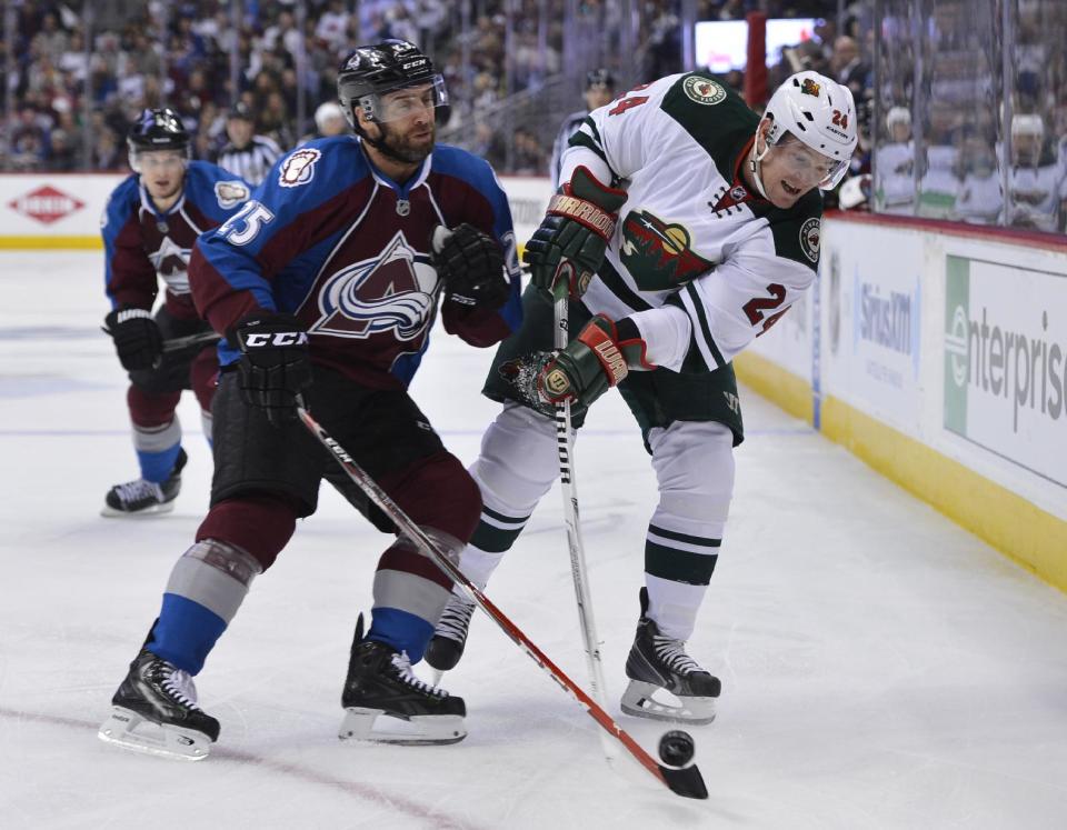 Colorado Avalanche center Maxime Talbot (25) and Minnesota Wild left wing Matt Cooke (24) skate in the first period of Game 2 of an NHL hockey first-round playoff series on Saturday, April 19, 2014, in Denver. (AP Photo/Jack Dempsey)
