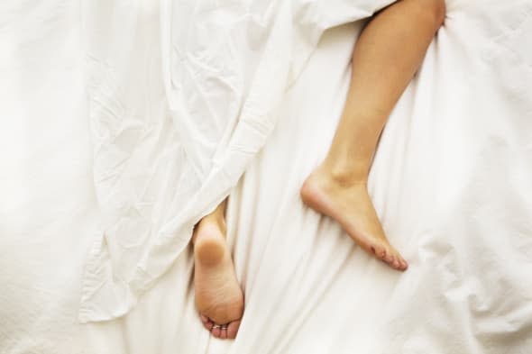 A woman's legs wrapped in a sheet