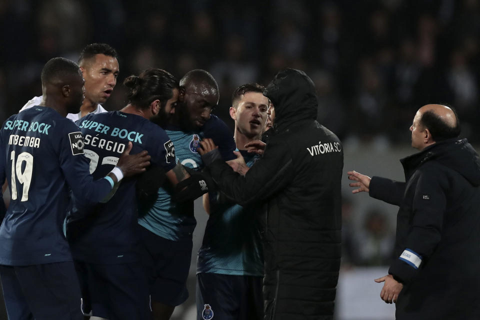 Porto's Moussa Marega, from Mali, fourth left, leaves the pitch during a Portuguese league soccer match between Vitoria SC and FC Porto in Guimaraes, Portugal, Sunday, Feb. 15, 2020. The president and the prime minister of Portugal have added their voices to a national outcry over racist abuse aimed at Moussa Marega who walked off the field after hearing monkey chants. (AP Photo)