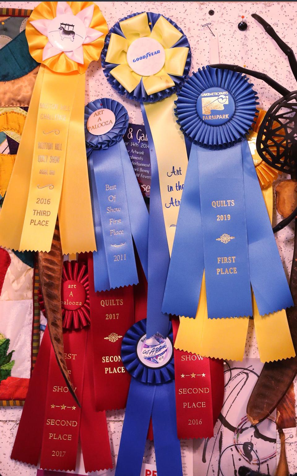 Prize ribbons hang on a wall in Wendy Lewis' quilting room in Green.