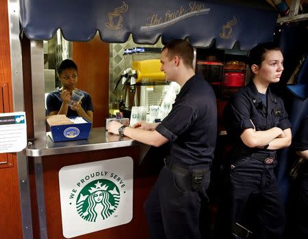 US Navy sailors wait in line for Starbucks coffee on board of the USS Harry S. Truman aircraft carrier in the eastern Mediterranean Sea, June 14, 2016. REUTERS/Baz Ratner