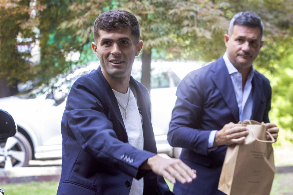 United States soccer player Christian Pulisic, front, waves as he arrives in Milan, Italy, Wednesday, July 12, 2023, for medical tests at Italian Serie A soccer team AC Milan before an expected transfer from British club FC Chelsea. (Stefano Porta/LaPresse via AP)