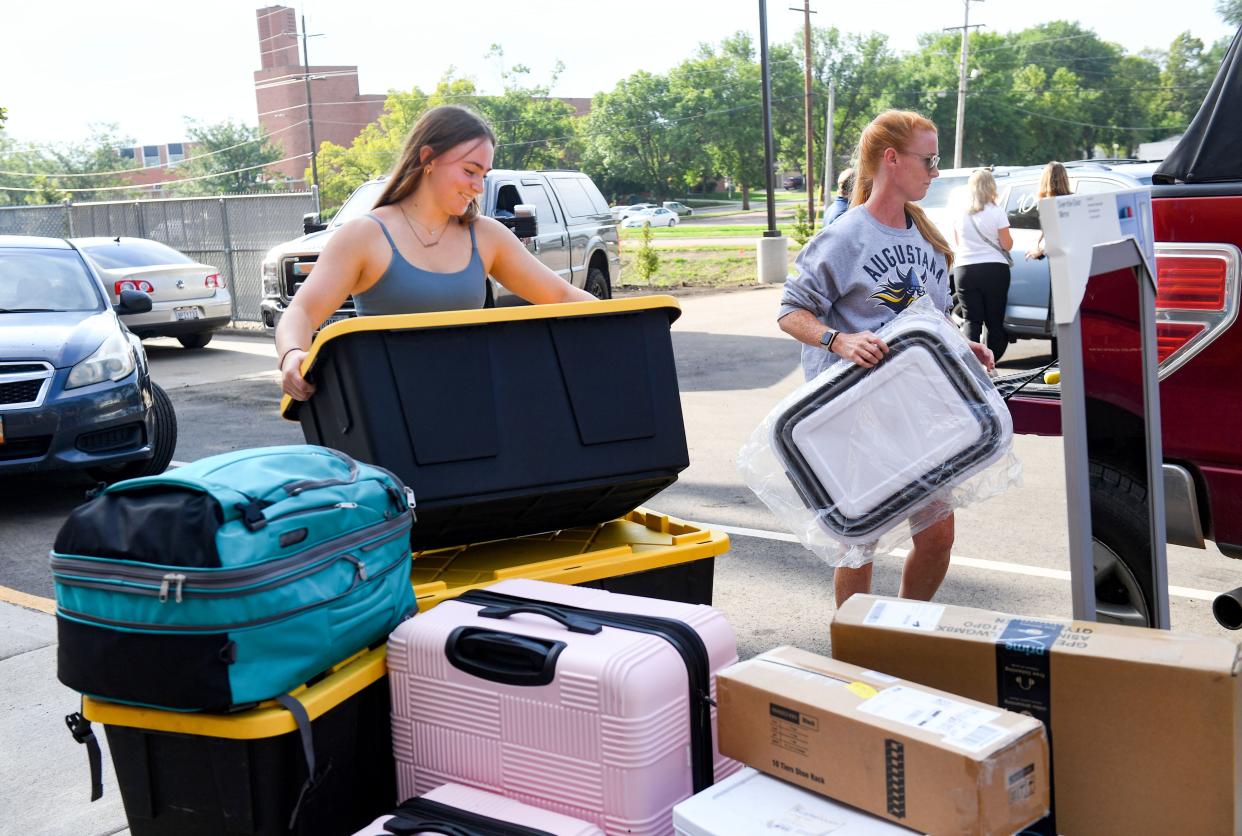 Norah Schumacher and her mom, Annie Schumacher, unload the car with Norah's possessions to move into her new dorm on Saturday, August 27, 2022, at Augustana University in Sioux Falls.