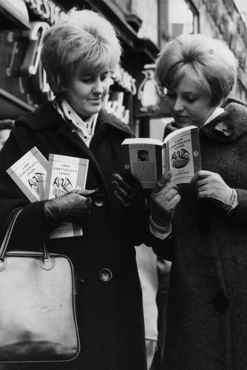 Un-banned: Two women scan through copies of ‘Lady Chatterley’s Lover’ in 1960, after it was determined to not be obscene (Getty Images)