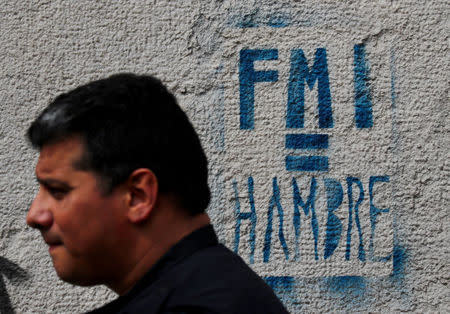 A man walks past a graffiti that reads “IMF=Hunger” in Buenos Aires, Argentina September 12, 2018. REUTERS/Marcos Brindicci