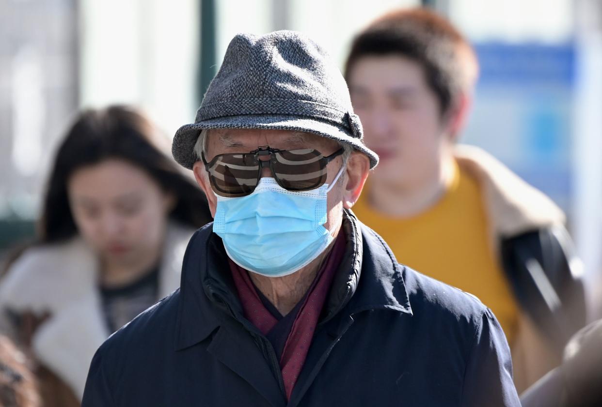 People wear surgical masks in fear of the coronavirus in Flushing, a neighborhood in the New York City borough of Queens on February 3, 2020. - China's top leadership on Monday admitted "shortcomings and difficulties" in its response to the coronavirus outbreak and the government said it "urgently" needed medical supplies to battle the outbreak which has killed more than 360 people.The virus has since spread to more than 20 countries despite many governments imposing unprecedented travel bans on arrivals coming from China. (Photo by Johannes EISELE / AFP) (Photo by JOHANNES EISELE/AFP via Getty Images)