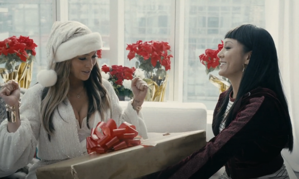 Constance Wu and Jennifer Lopez exchanging Christmas gifts in "Hustlers"