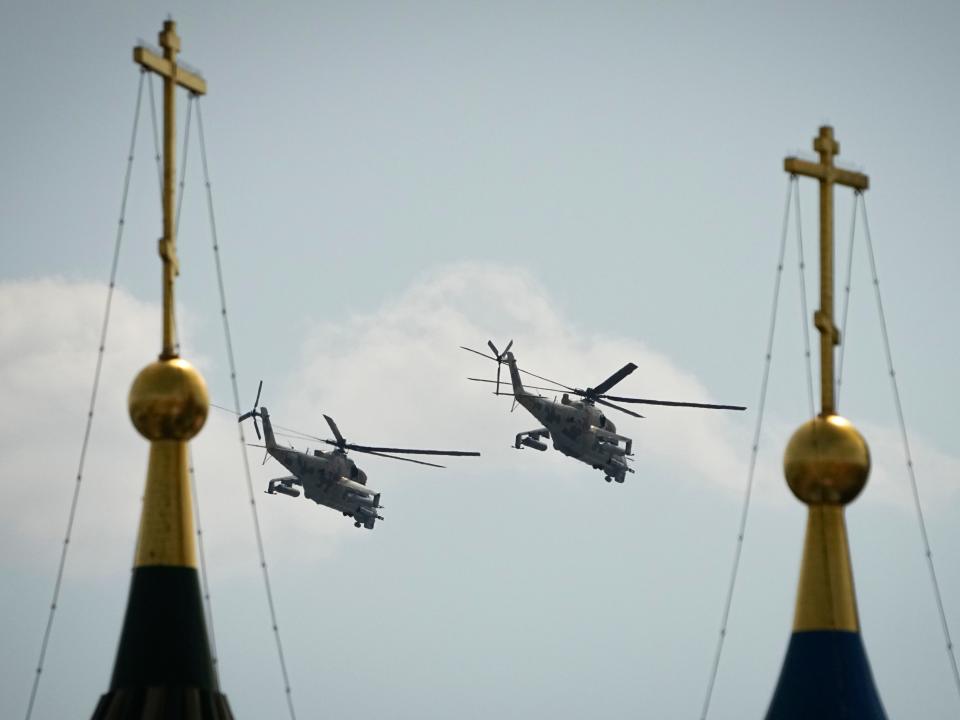 Российские военные вертолеты пролетают над Красной площадью во время репетиции военного парада в честь Дня Победы в Москве, Россия, суббота, 7 мая 2022 года.