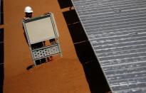 A worker sets up the photovoltaic panels at the Benban plant in Aswan