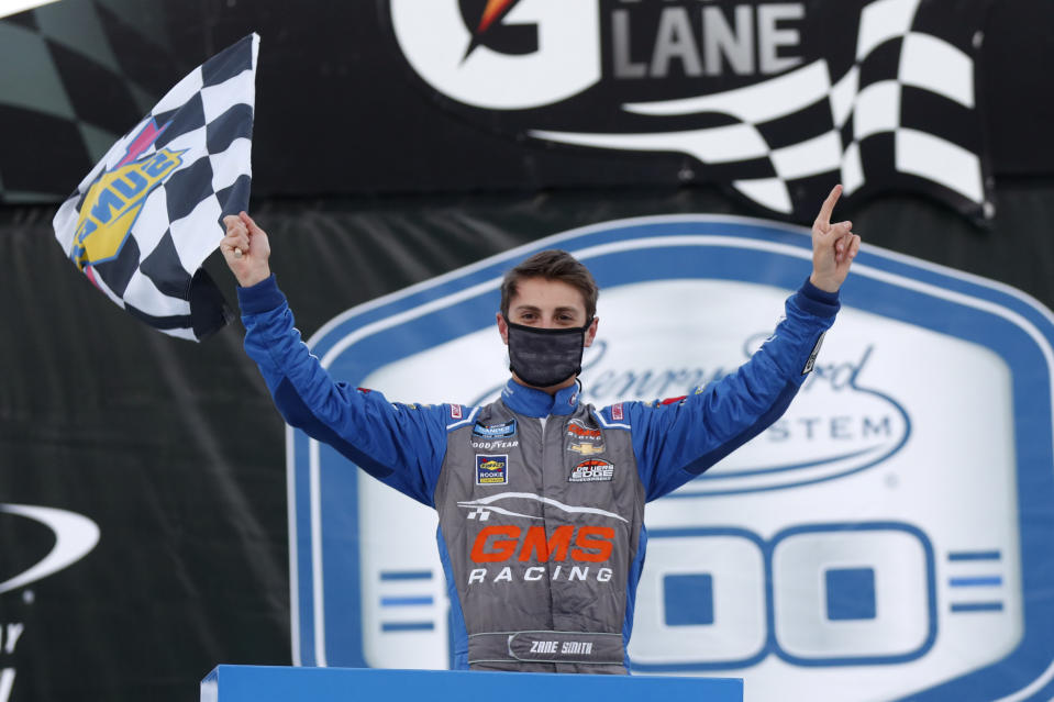 Zane Smith celebrates his victory after a NASCAR Truck Series auto race at Michigan International Speedway in Brooklyn, Mich., Friday, Aug. 7, 2020. (AP Photo/Paul Sancya)