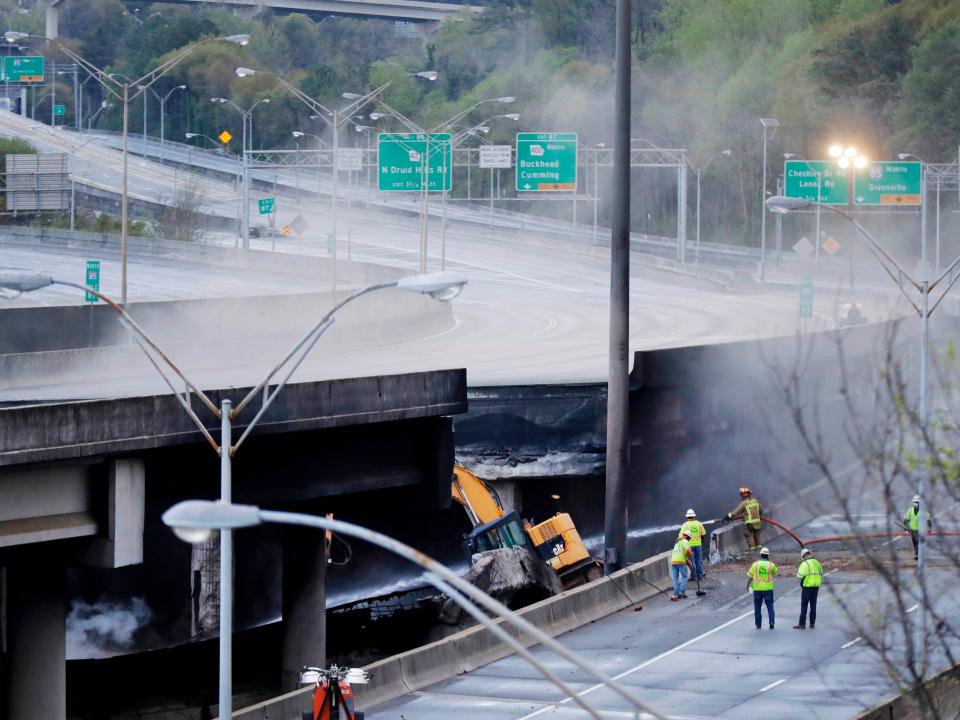 Crews work on a section of an overpass that collapsed from a large fire on Interstate 85 in Atlanta.