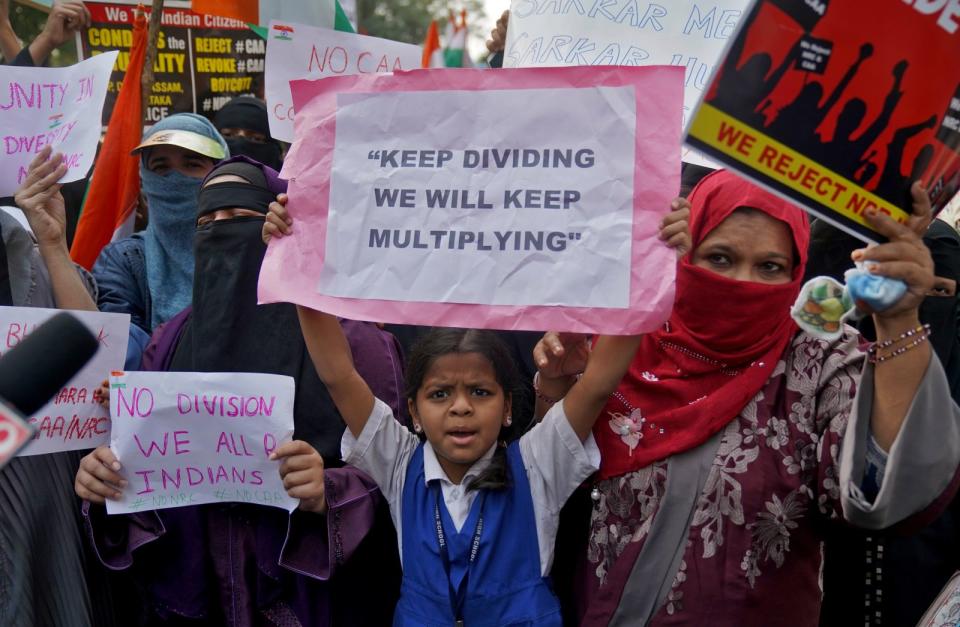 Demonstrators holding placards shout slogans as they attend a protest rally against a new citizenship law, in Hyderabad