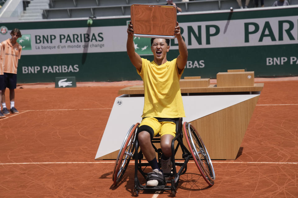 Japan's Tokito Oda holds the trophy after winning against Argentina's Gustavo Fernandez in the men's wheelchair final match of the French Open tennis tournament at the Roland Garros stadium in Paris, France, Saturday, June 8, 2024. (AP Photo/Christophe Ena)