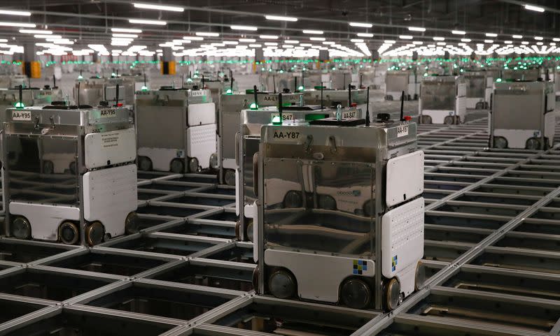 Ocado robots are seen inside a warehouse in Erith