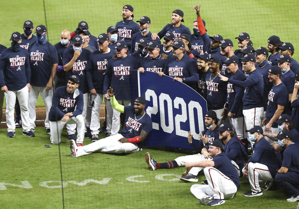 The Atlanta Braves celebrate clinching their third consecutive National League East championship after with a victory over the Miami Marlins in a baseball game on Tuesday, Sept. 22, 2020, in Atlanta. (Curtis Compton/Atlanta Journal-Constitution via AP)