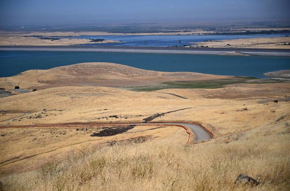 The foothills near the Basalt Day Use area is seen with the B.F. Sisk Dam in the background at San Luis Reservoir Thursday, Aug. 8, 2024 near Los Banos. O’Neill Forebay is the water body in the far background beyond the dam.