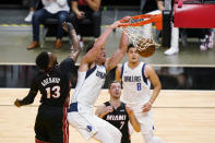 Dallas Mavericks center Dwight Powell (7) dunks the ball against Miami Heat center Bam Adebayo (13) and guard Goran Dragic (7) as guard Josh Green (8) looks on during the first half of an NBA basketball game, Tuesday, May 4, 2021, in Miami. (AP Photo/Wilfredo Lee)