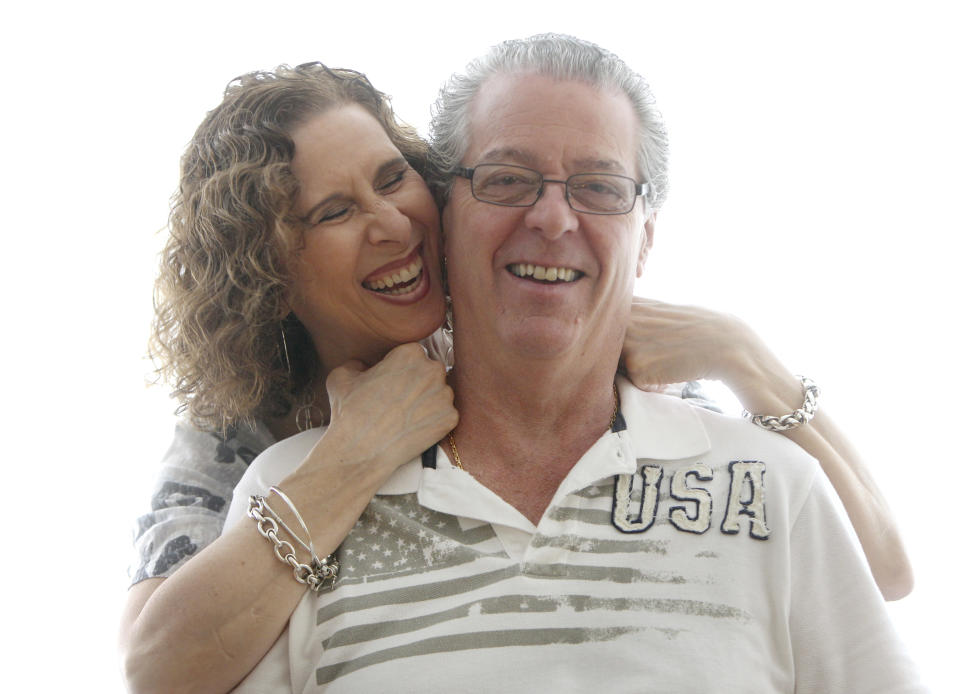 In this Sunday, July 8, 2012 photo, Jason and Karin Marder pose for a picture in their home in New York. Jason Marder, who turned 70 on Tuesday, July 10, 2012, was diagnosed with Alzheimer's more than eight years ago. In the roughly five years that her husband has taken Gammagard, "there has been decline" in his health but it is very minimal and the kind of slowing down you might expect from ordinary aging, she said. "He travels the subways, he does things that you and I do. And our quality of life together is what's most important." (AP Photo/Seth Wenig)